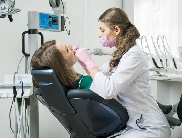 Dentist examining patient's teeth in modern dental office in Sharpsville, PA.